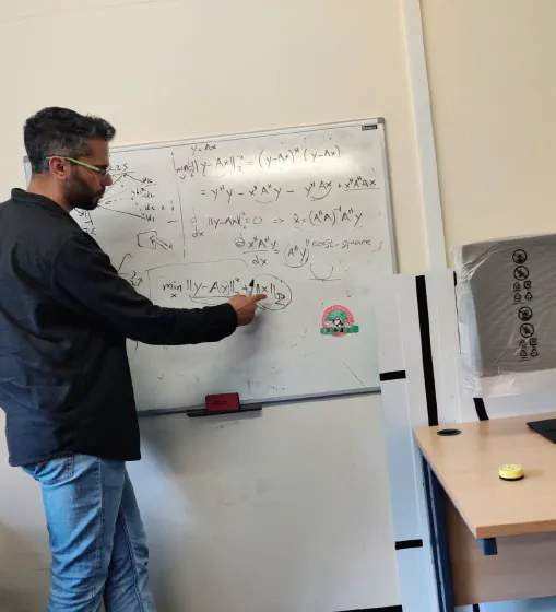 Working through equations on a whiteboard